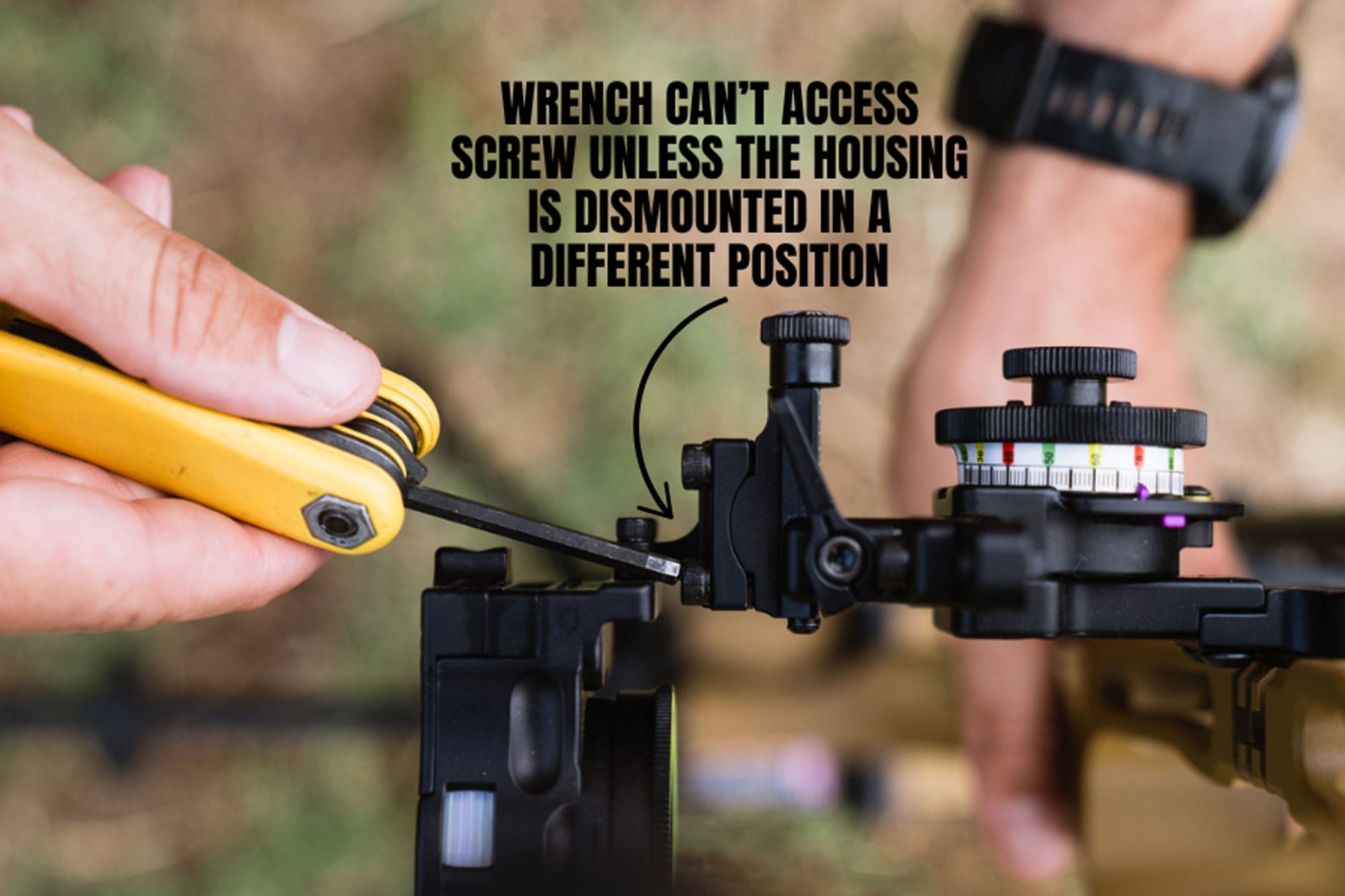 close-up-of-a-person-using-a-wrench-on-a-bow-sight Close-up of a person using a wrench on a bow sight